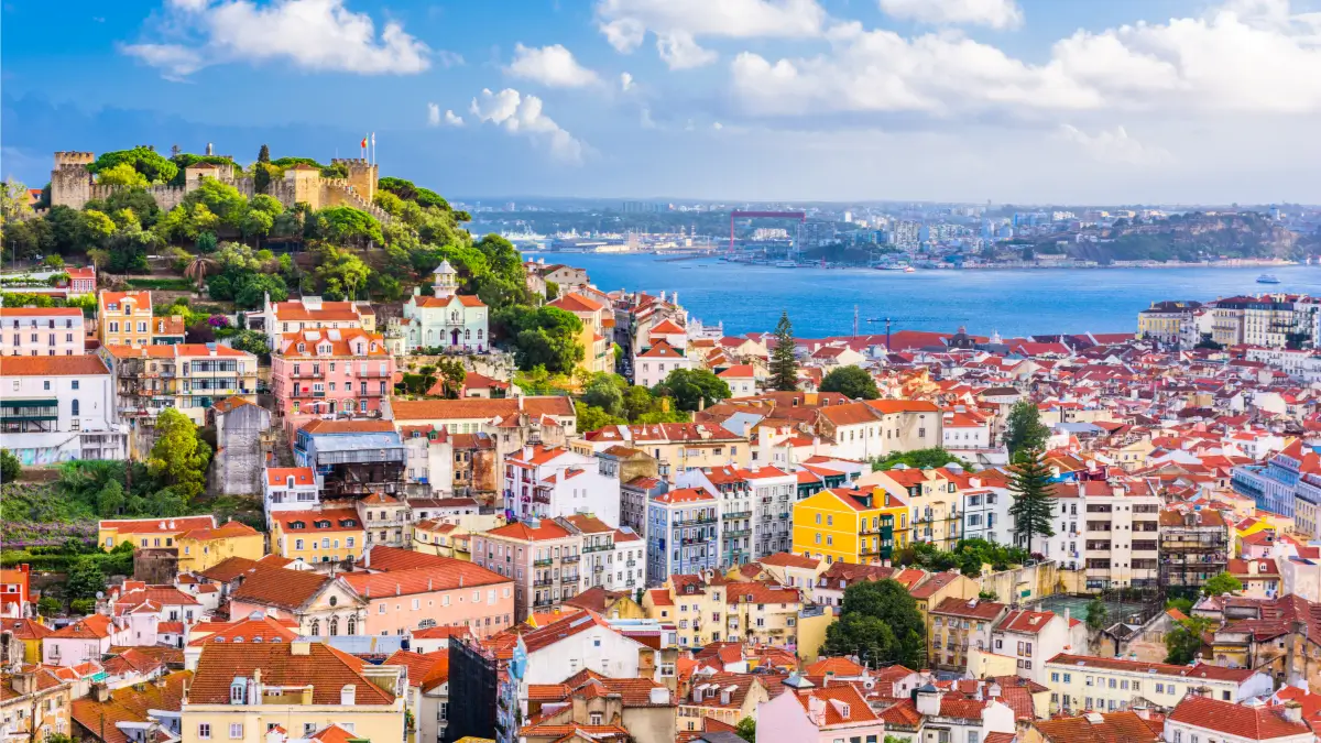 Lisbon sky view showing red titled buildings and the sea
